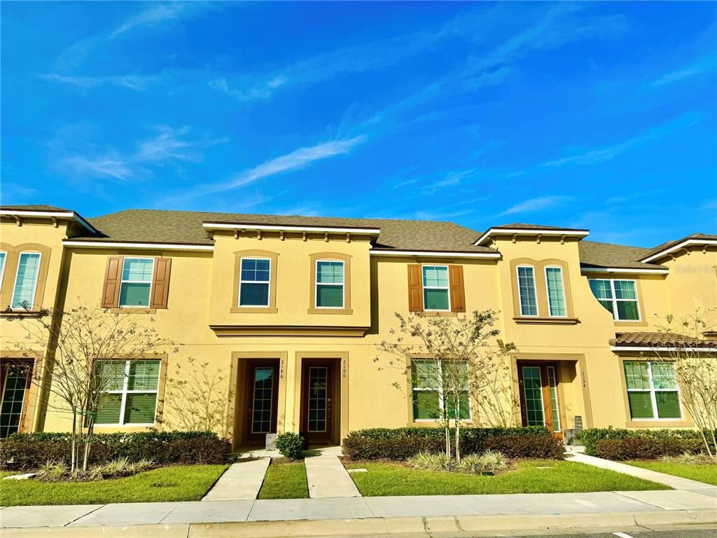 a front view of a residential houses with yard