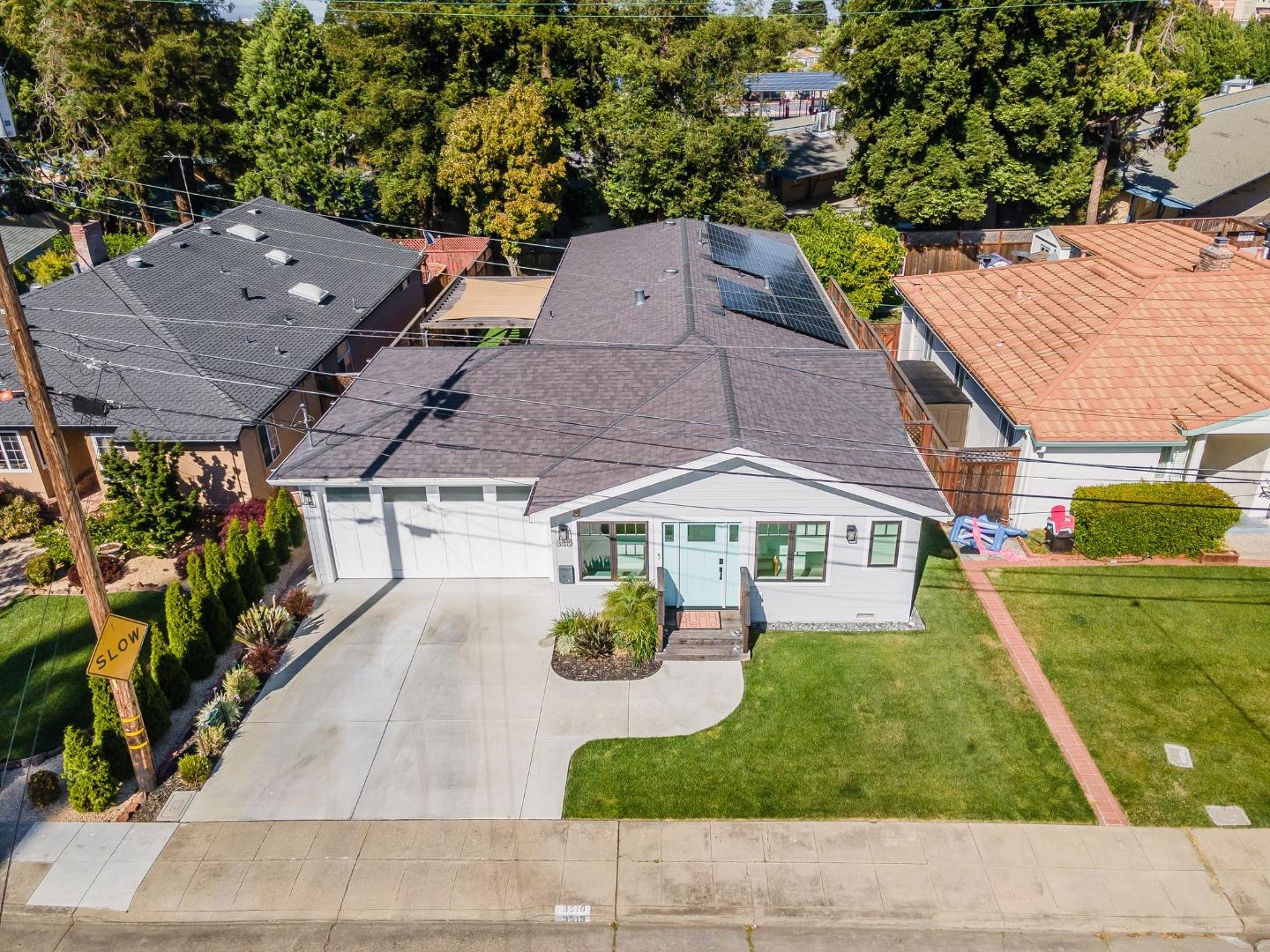 an aerial view of a house with garden space and a yard