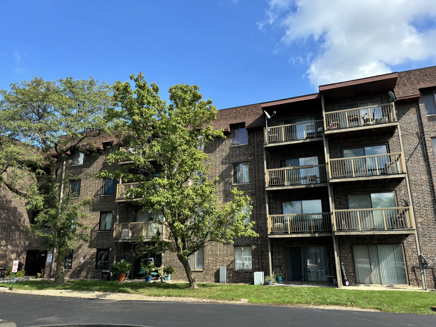 a front view of a building with trees