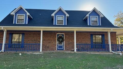 front view of brick house with a yard