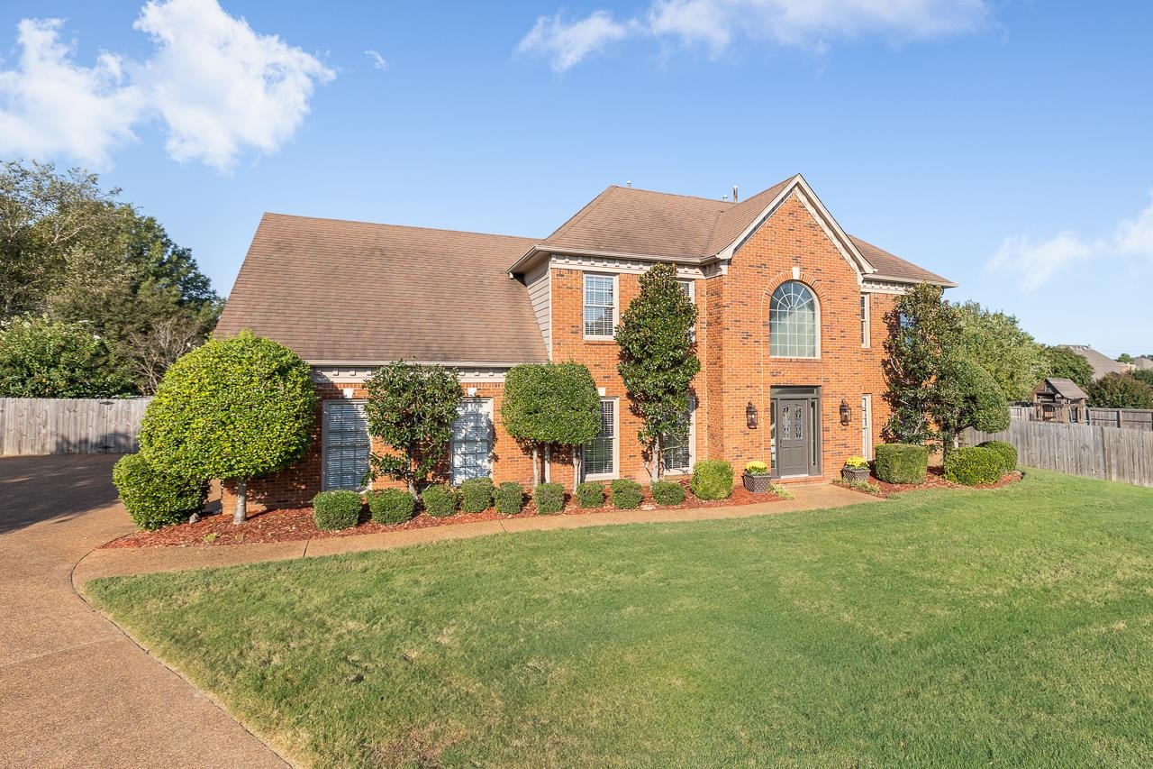 a front view of a house with a yard