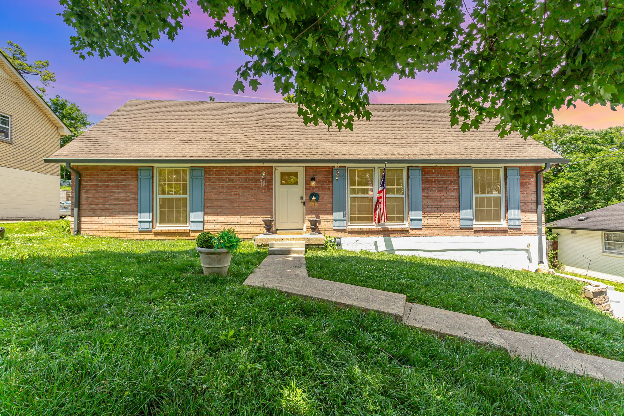 a front view of house with yard and green space