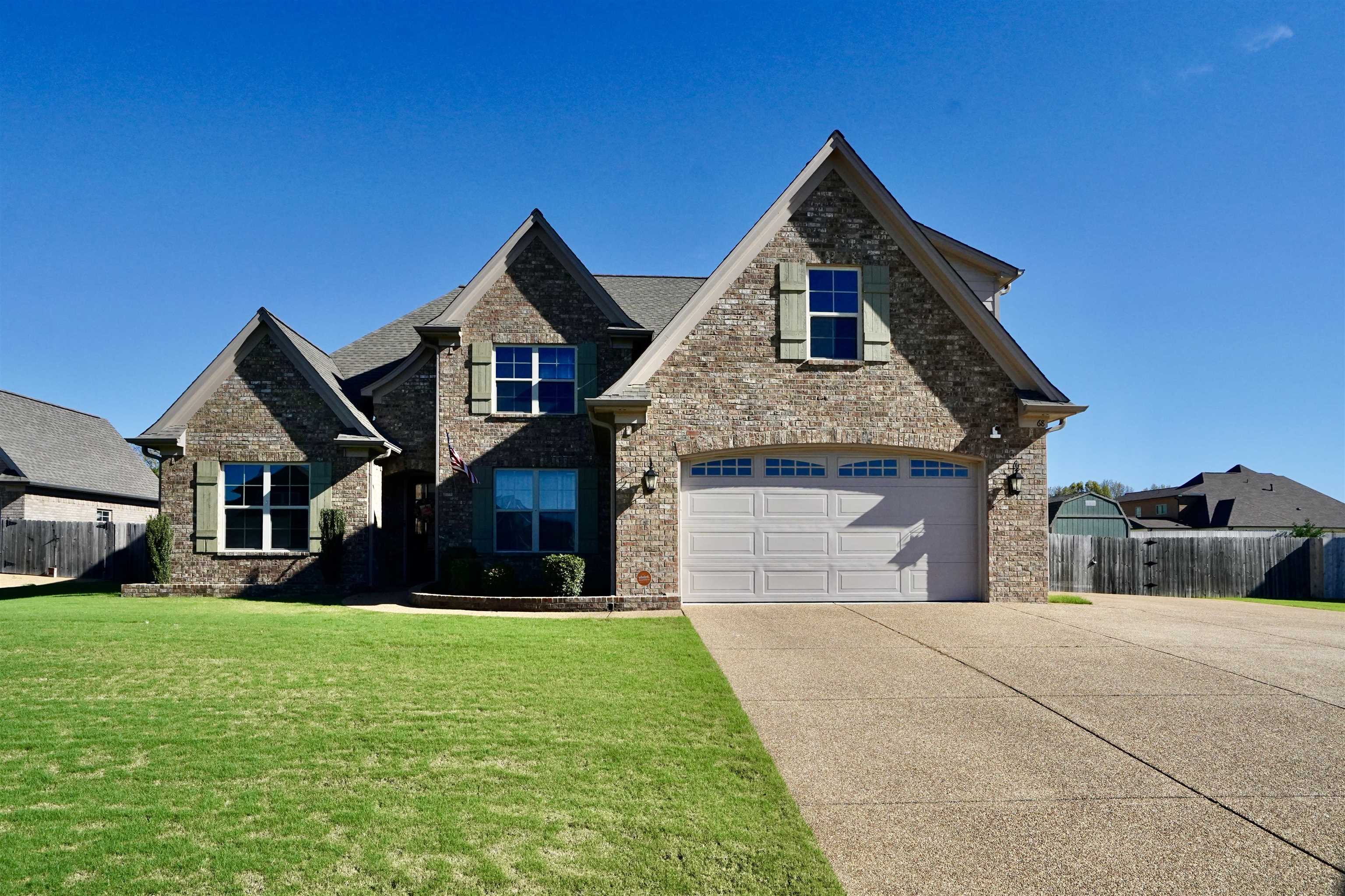 a front view of house with yard and green space