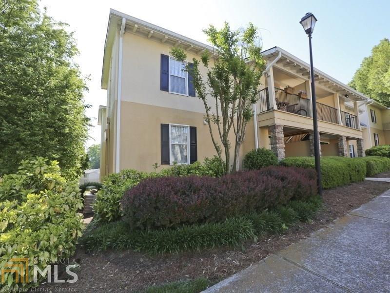 Exterior view of the condo building and attractive landscaping.