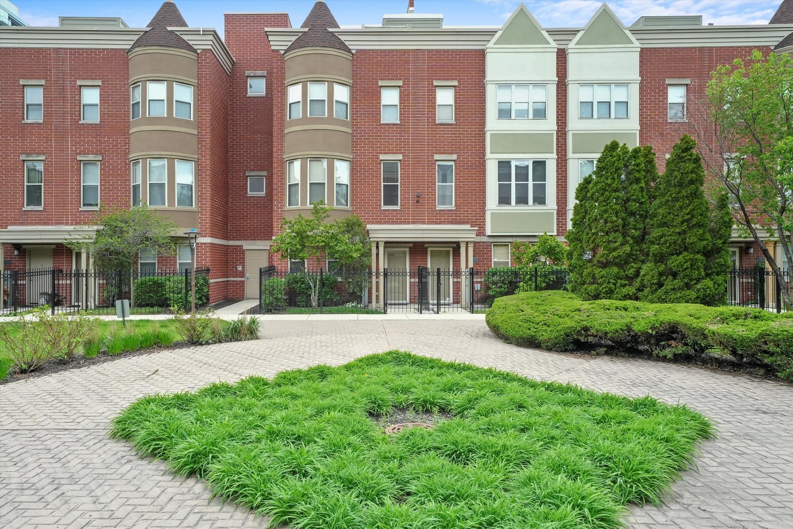 a view of a brick building next to a yard