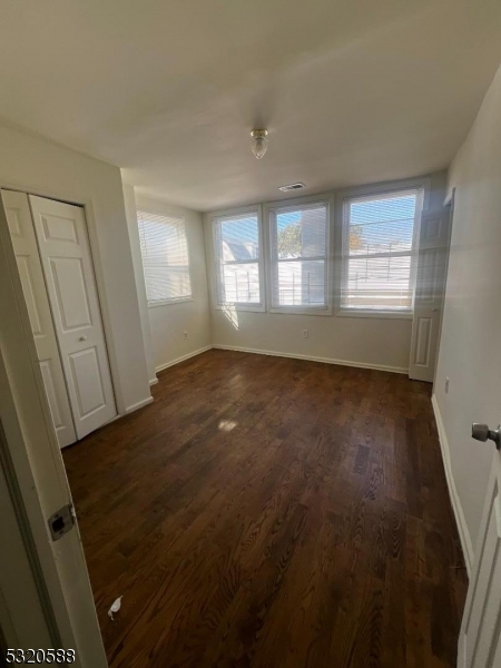 a view of room with window and hardwood floor