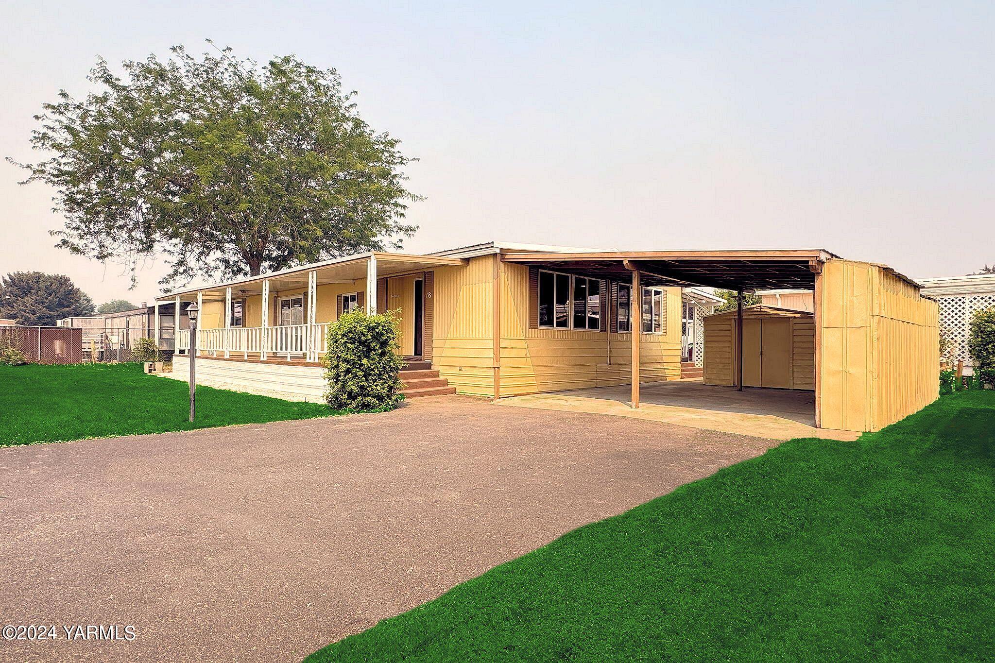 a front view of a house with a garden and garage