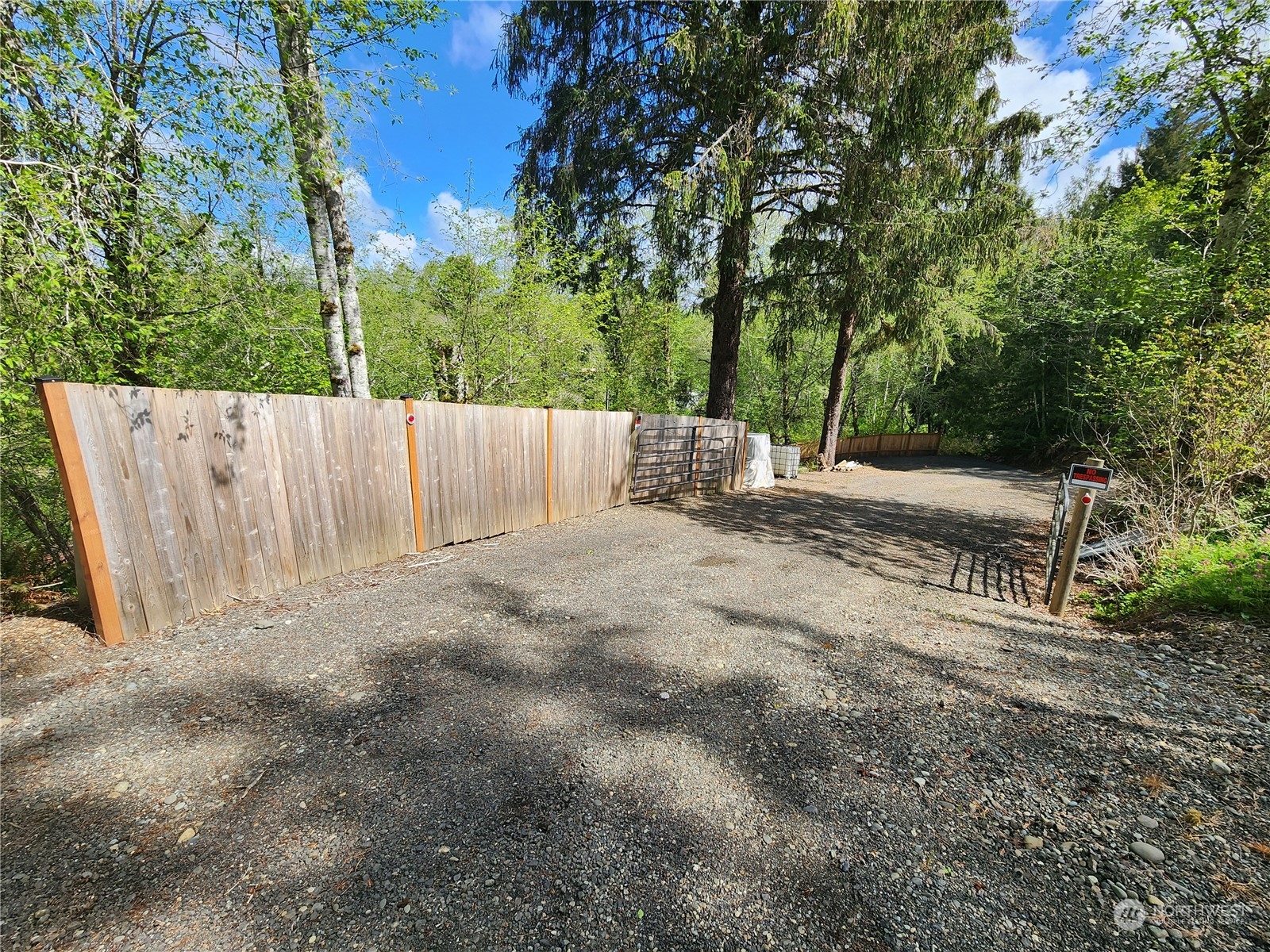 a view of backyard with a barn and large trees