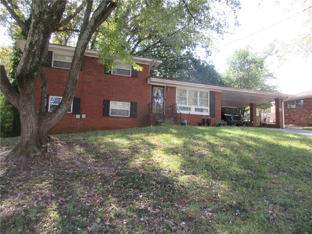 a brick house with a large tree