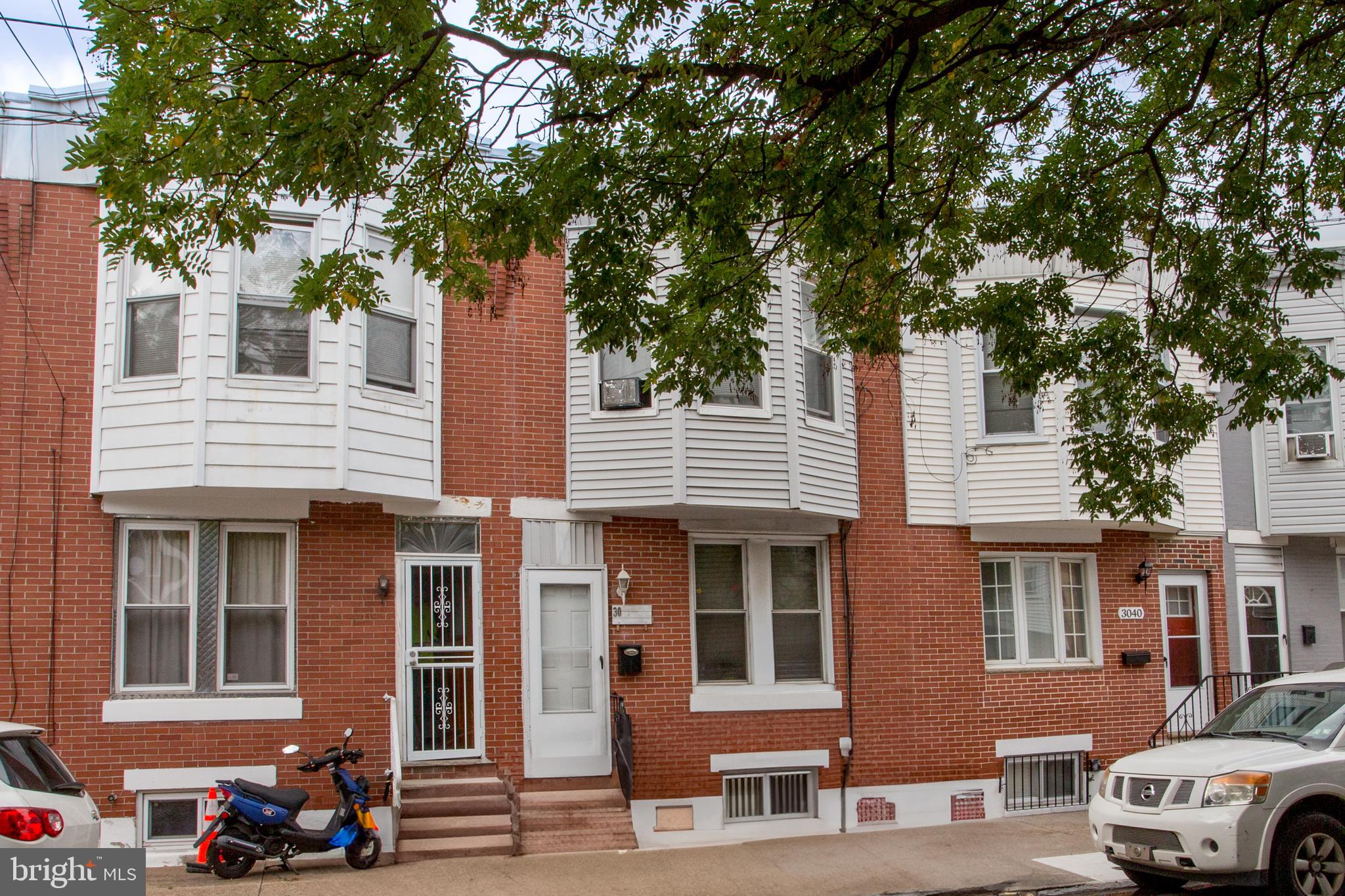 a front view of a residential apartment building with a yard