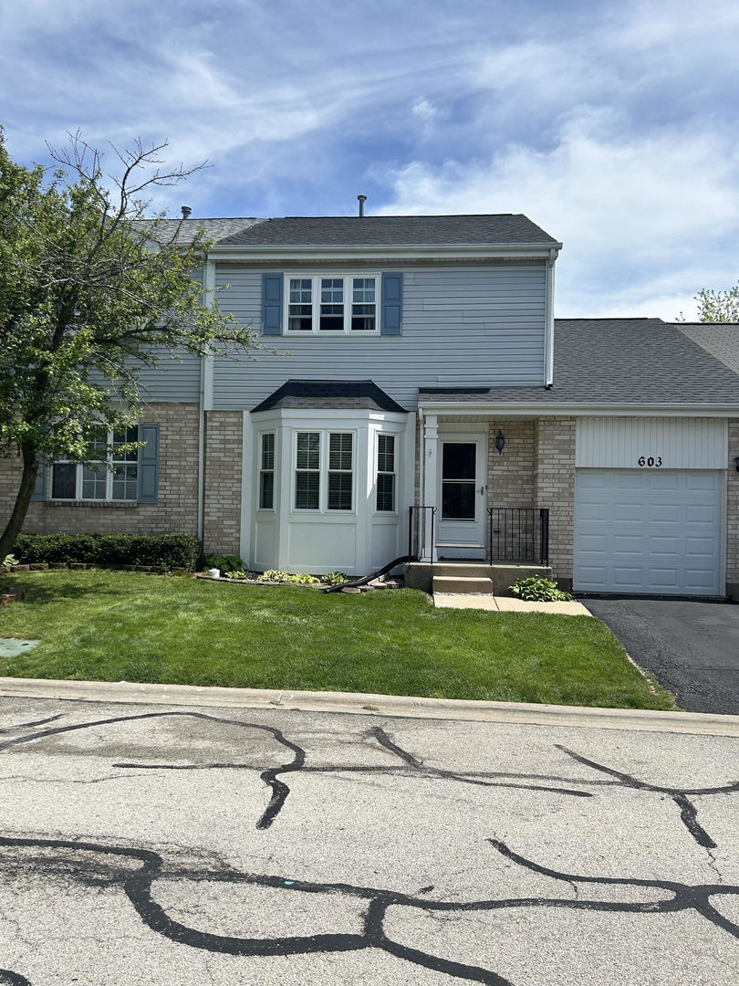 front view of a house with a yard