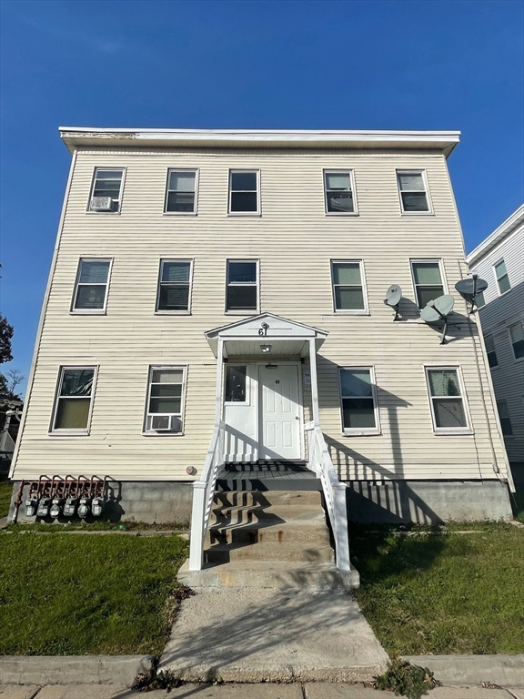 a view of a white building with many windows