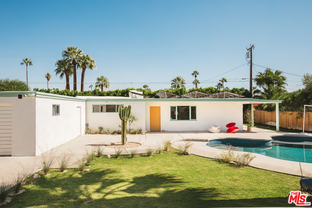 a front view of a house with swimming pool having outdoor seating