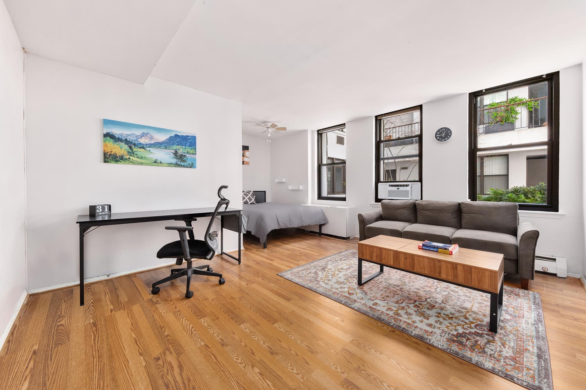 a living room with furniture and a wooden floor