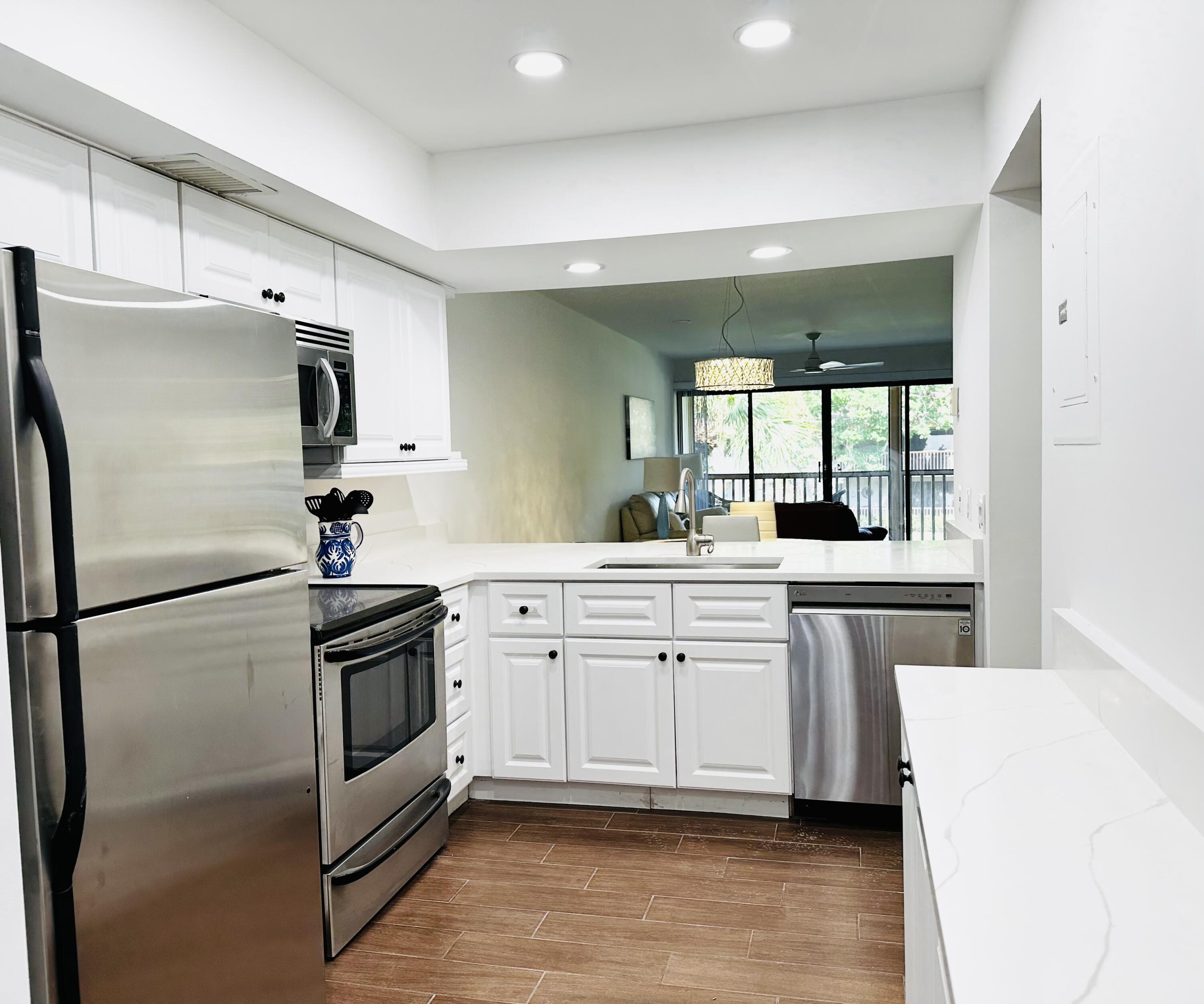 a kitchen with white cabinets and white appliances