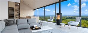 a living room with furniture and a floor to ceiling window