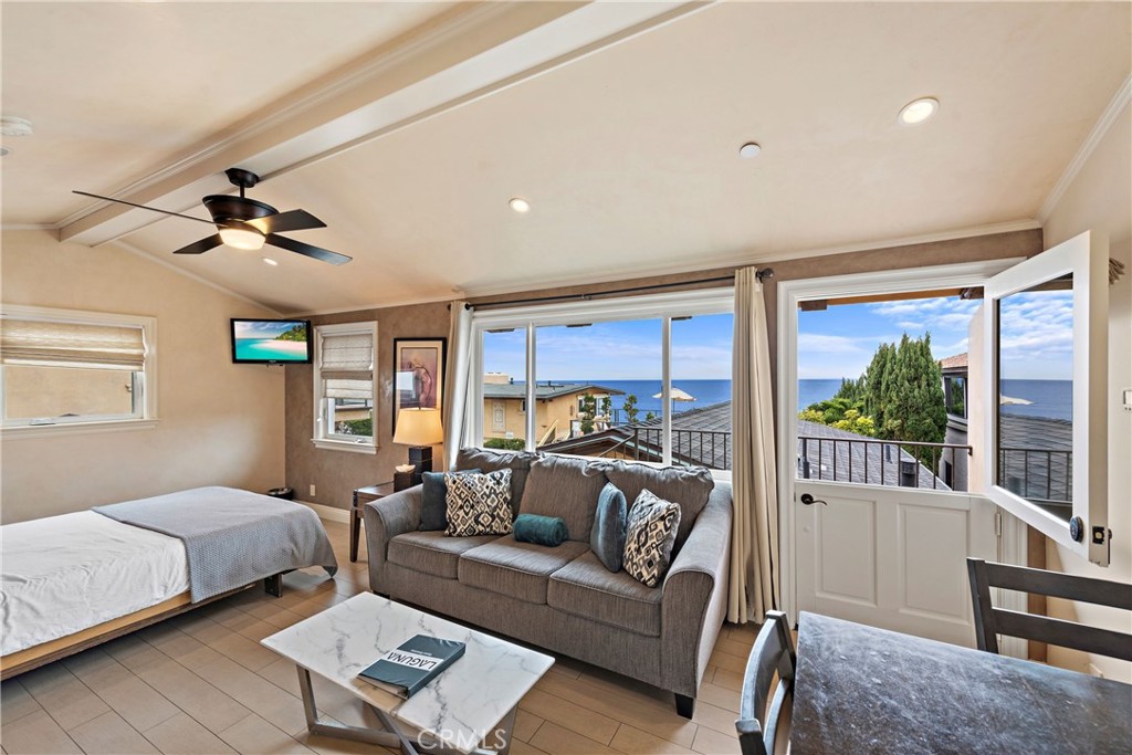 a bedroom with furniture and a large window