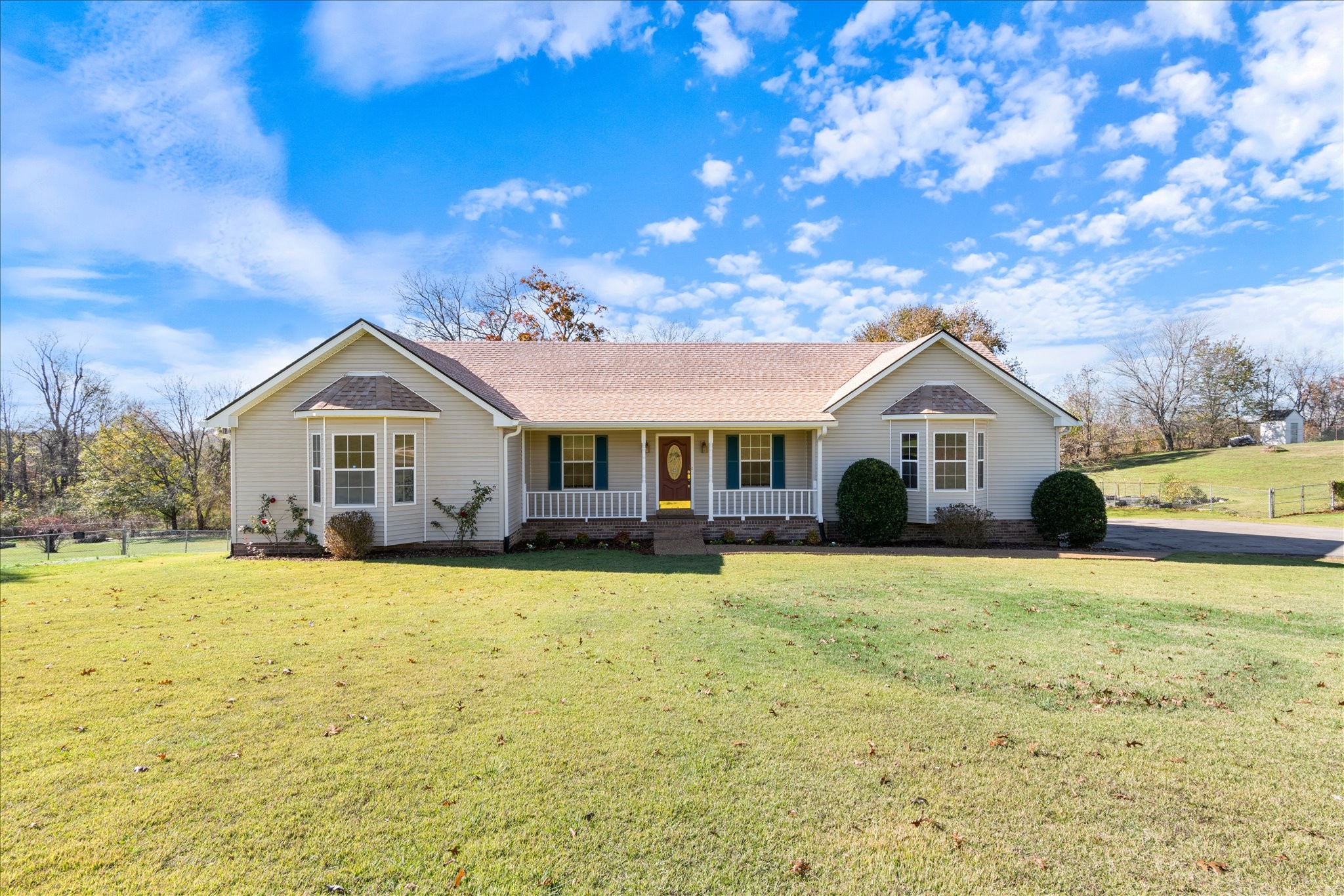 a front view of a house with yard and garage