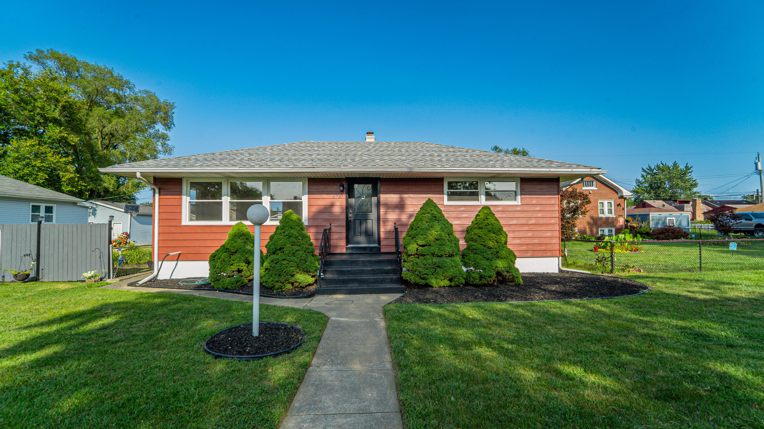 a front view of house with a garden