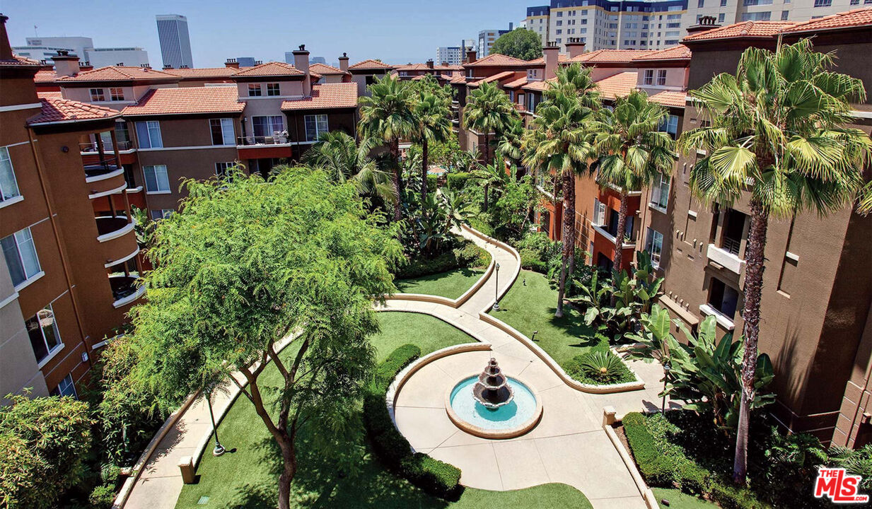 an aerial view of a house with swimming pool and garden view