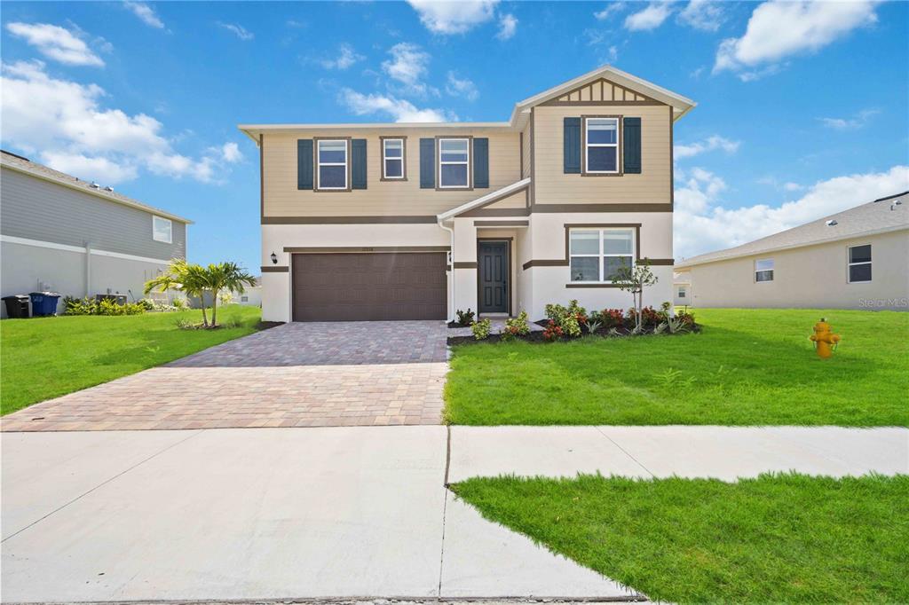 a front view of a house with a yard and garage