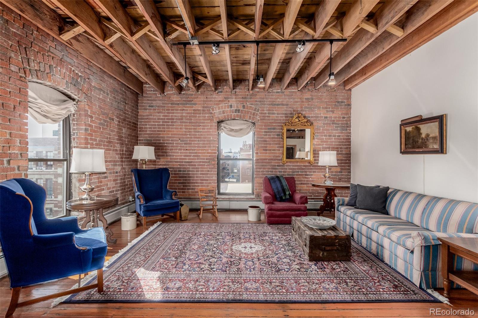 a living room with furniture wooden floor and a fireplace