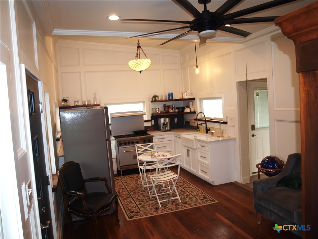 a kitchen with a refrigerator and a stove top oven