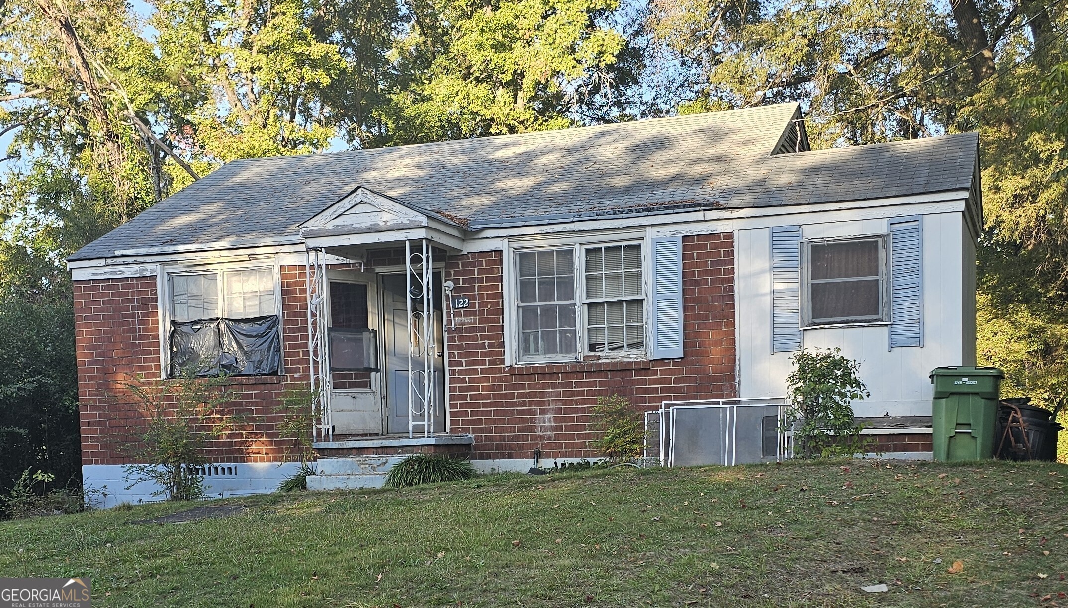 a front view of a house with a garden