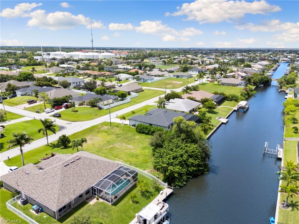 an aerial view of residential houses with outdoor space and ocean view