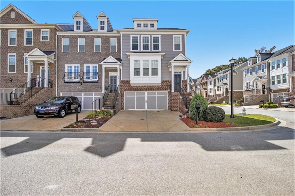 a front view of a residential apartment building with a yard