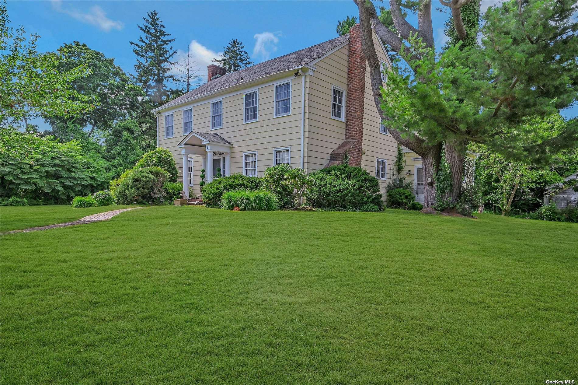 a view of a house next to a big yard