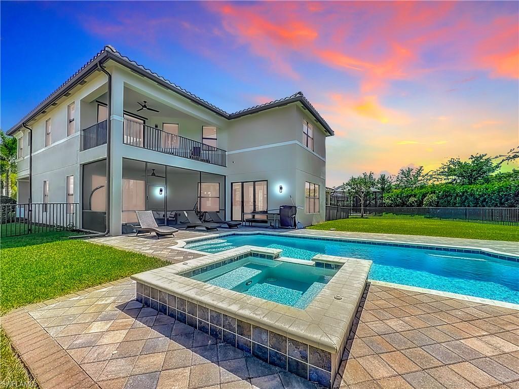 a view of a house with swimming pool and sitting area