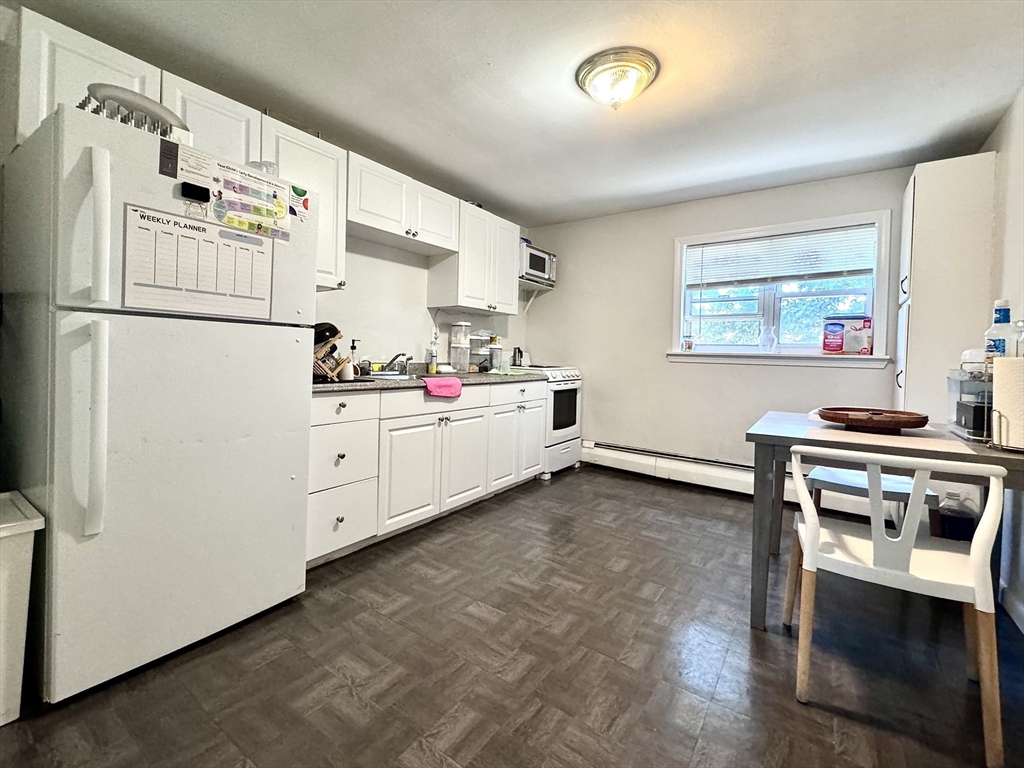 a kitchen with cabinets and white stainless steel appliances