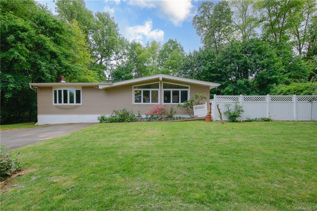 a front view of house with yard and green space