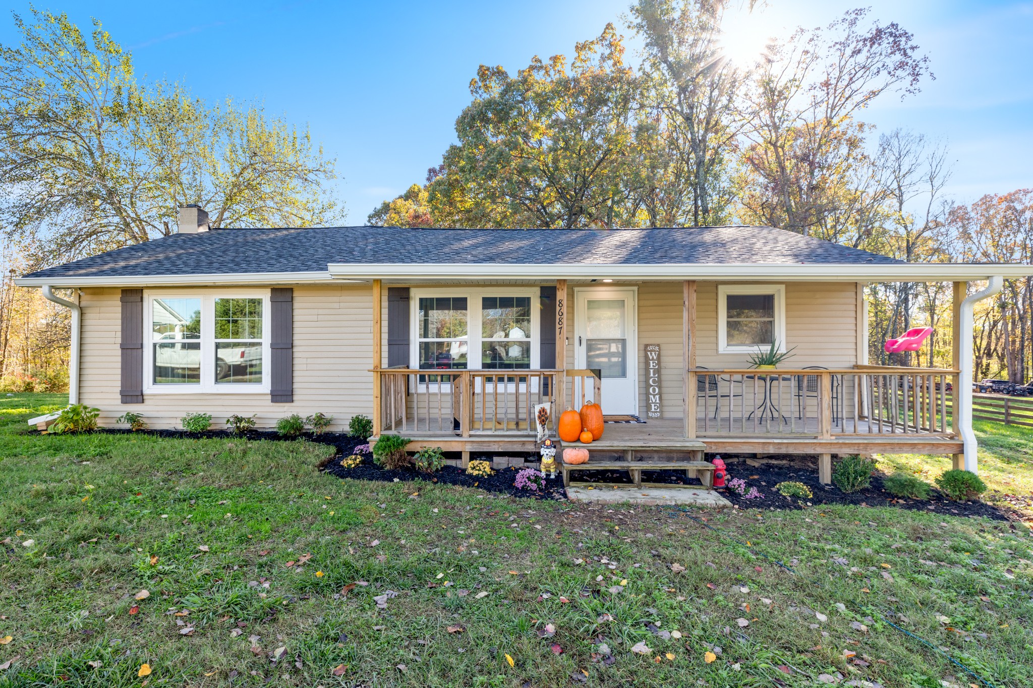 a front view of house with yard and green space