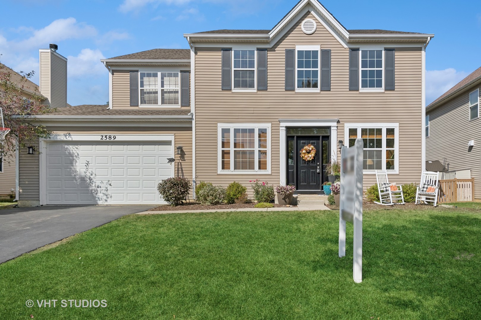 a front view of a house with a yard and garage