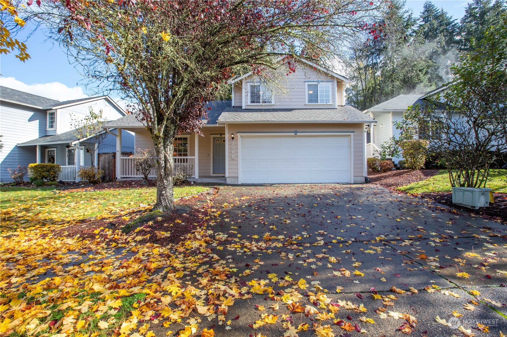 a front view of a house with a yard and garage