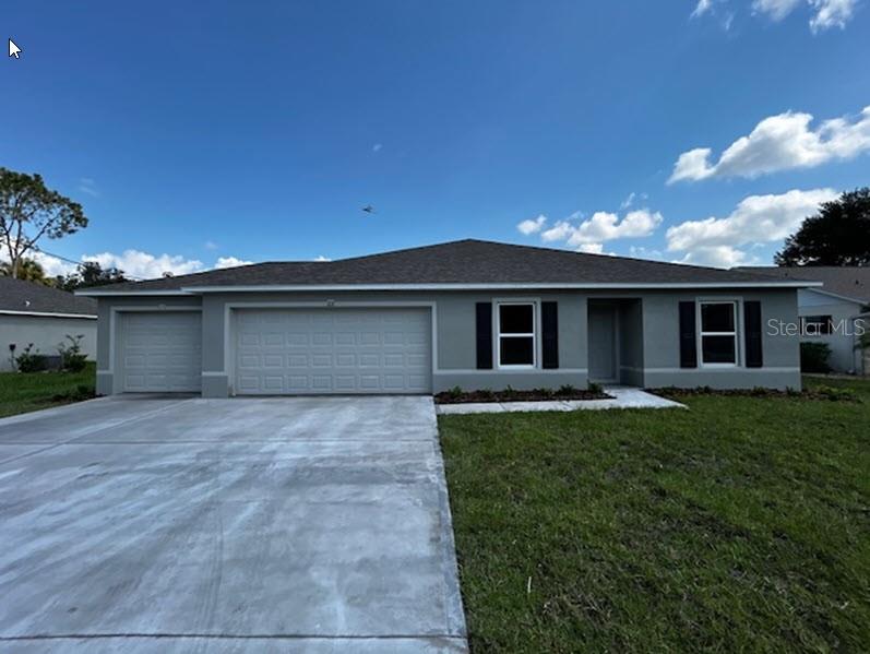 a front view of a house with a yard and garage