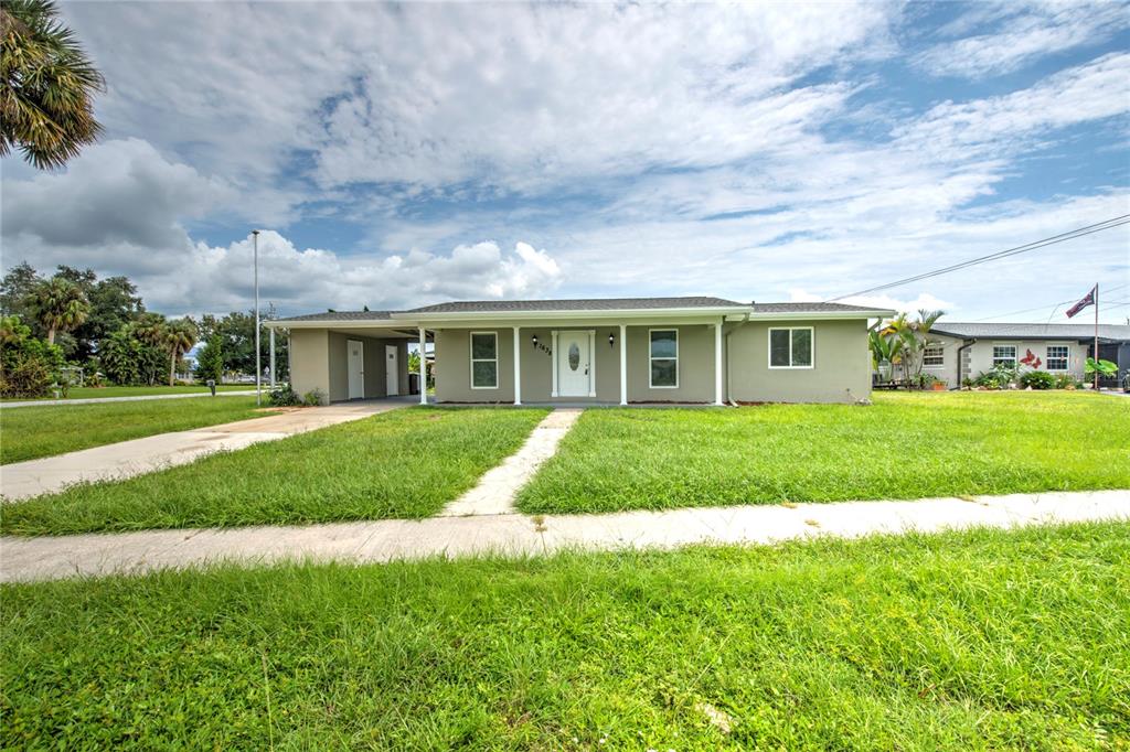 a view of house that has a yard