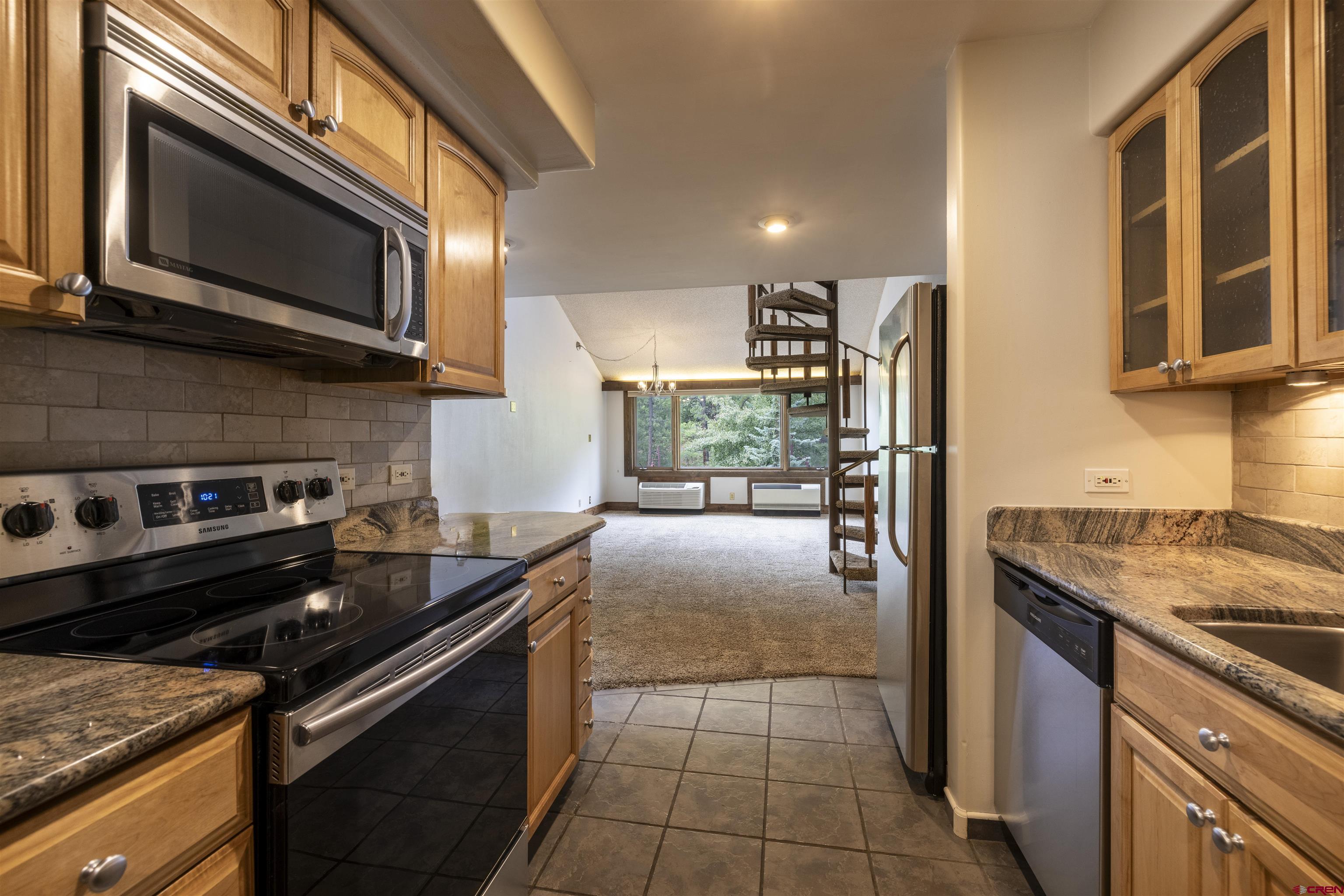 a kitchen with a stove microwave and sink