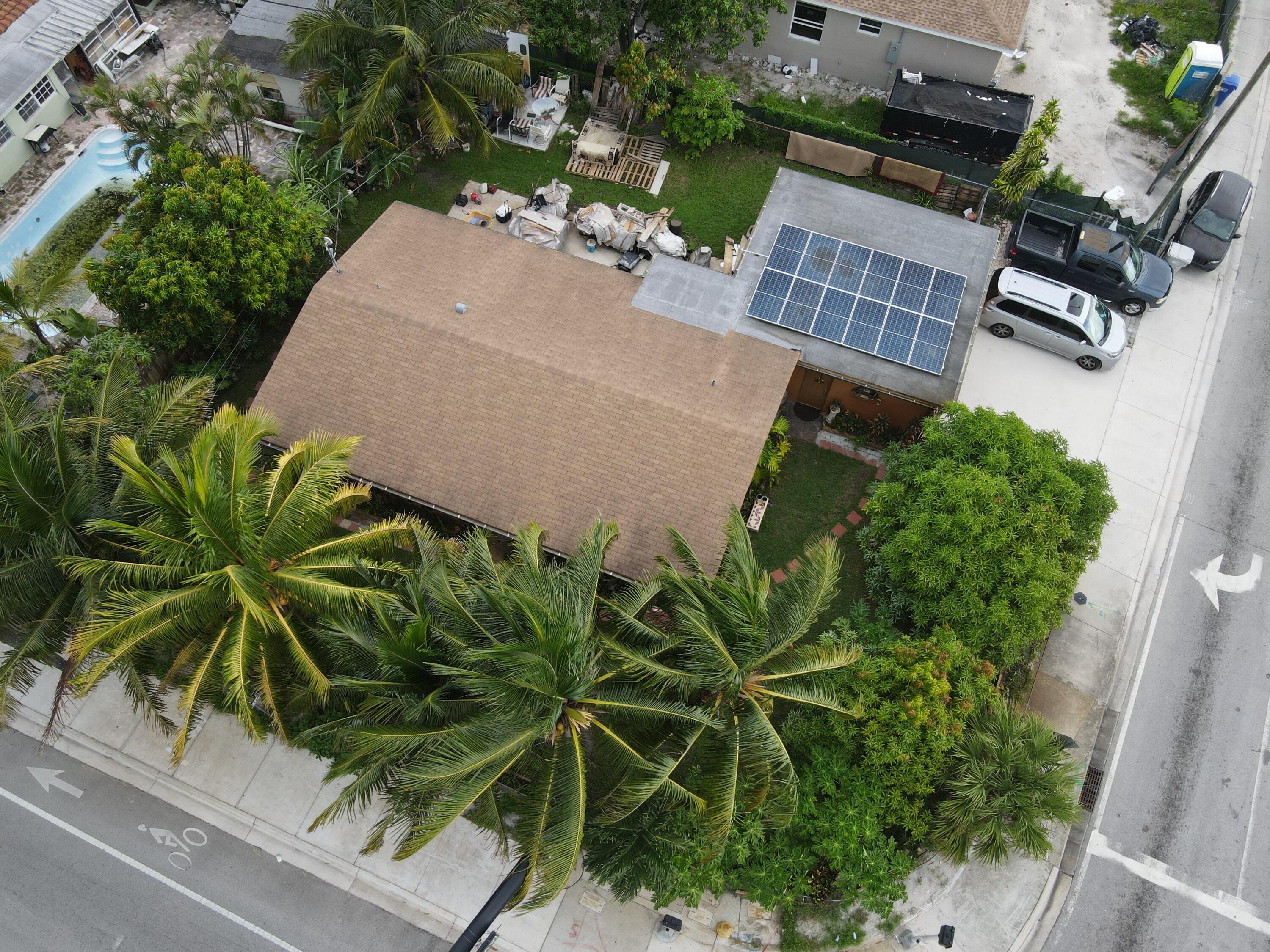 an aerial view of a house with backyard and garden