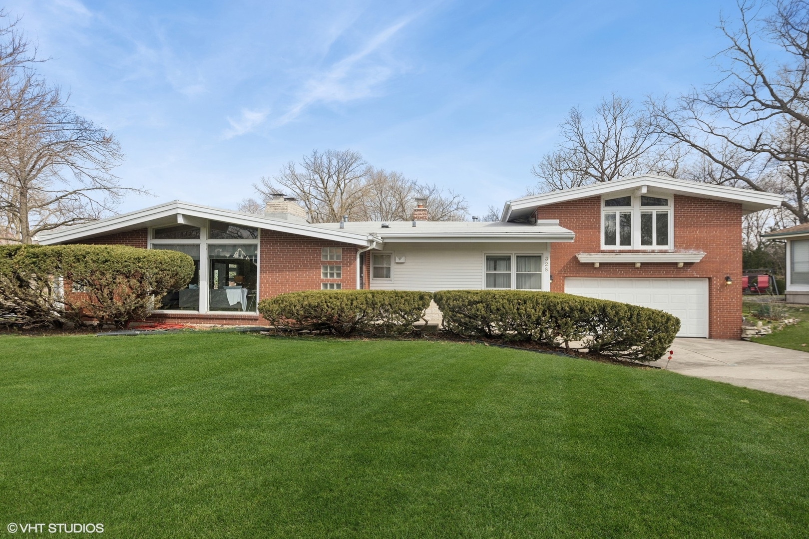 a front view of a house with a garden