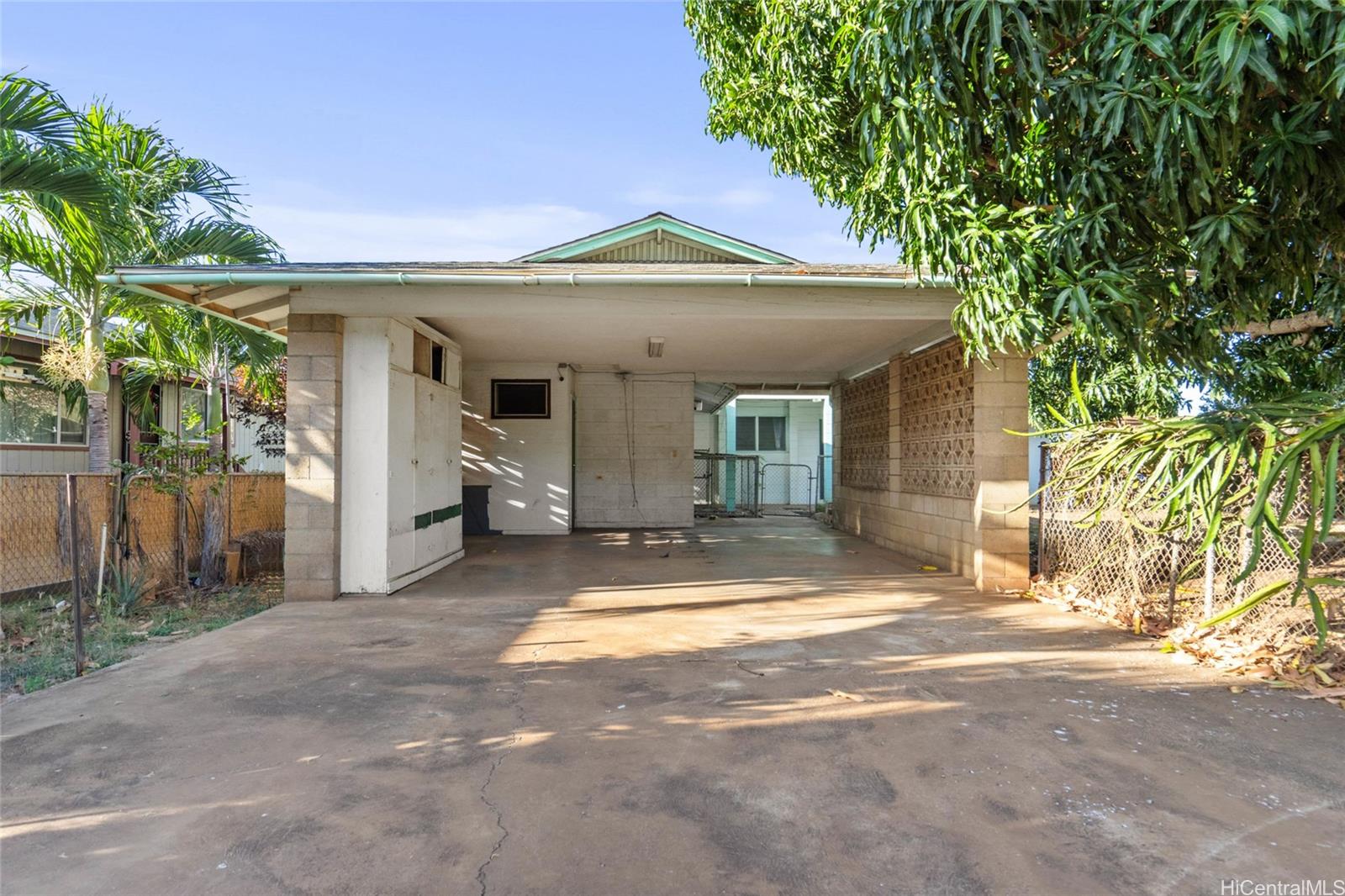 a view of a house with a patio and a yard