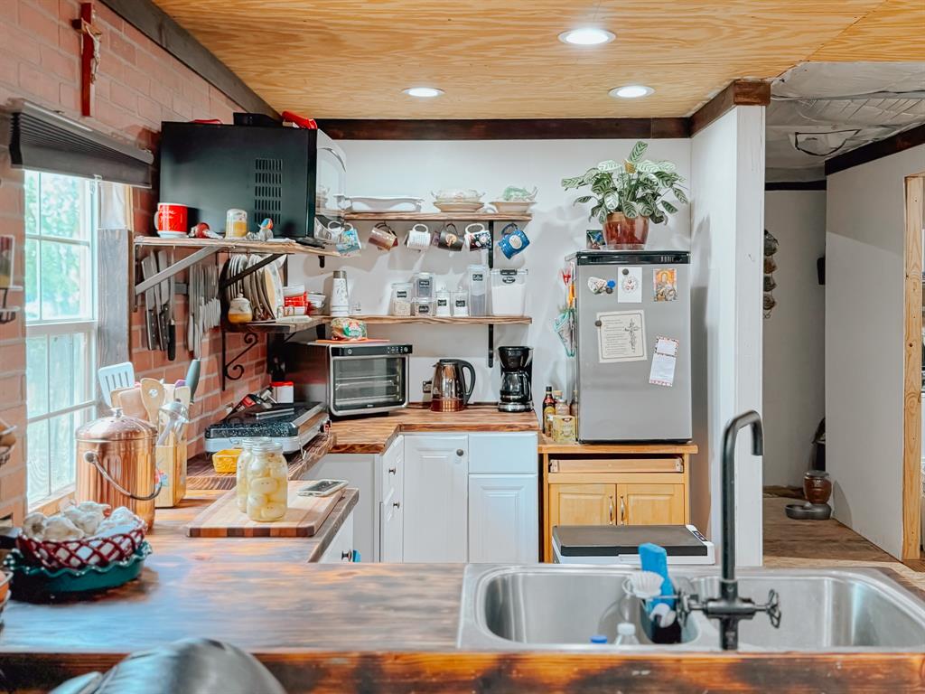 a living room with furniture a flat screen tv and a kitchen view