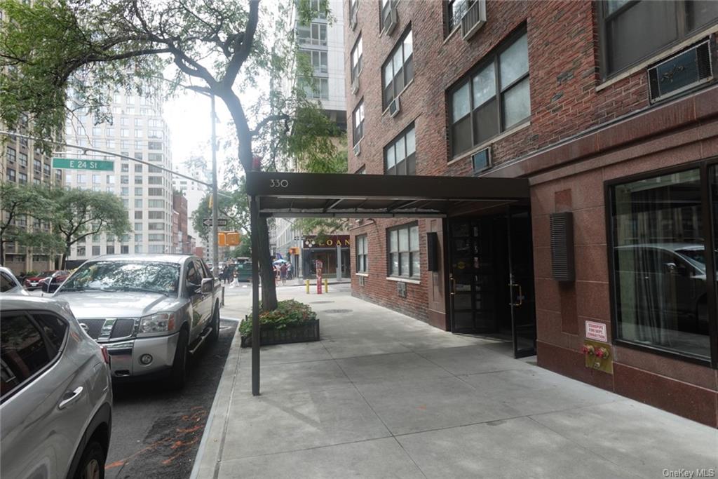 a view of a building with car parked