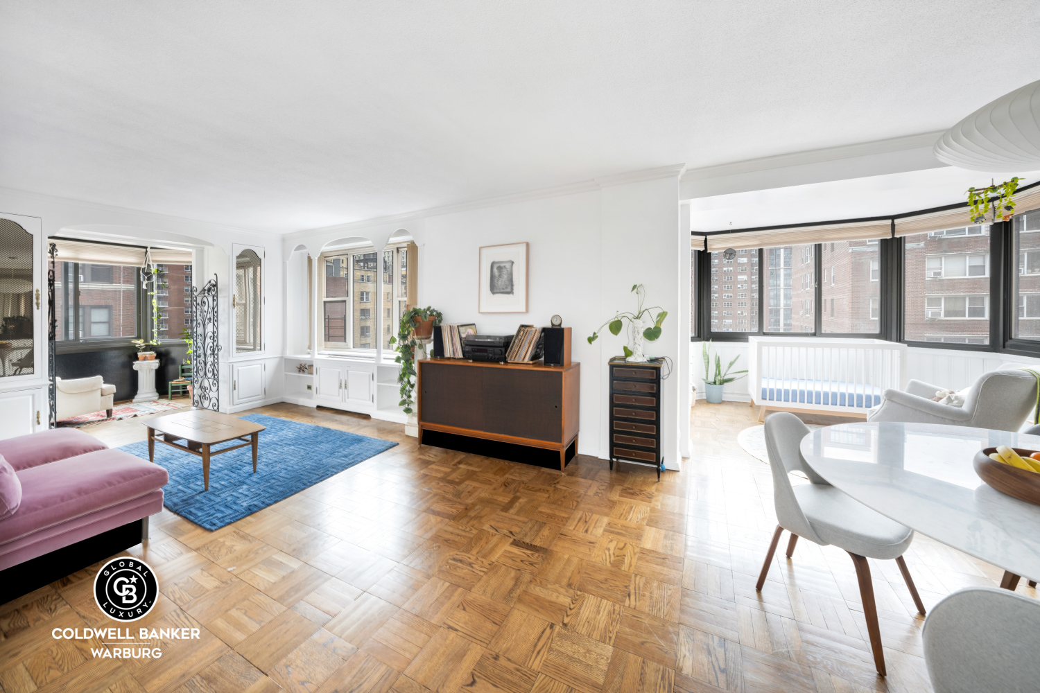 a living room with furniture and a wooden floor