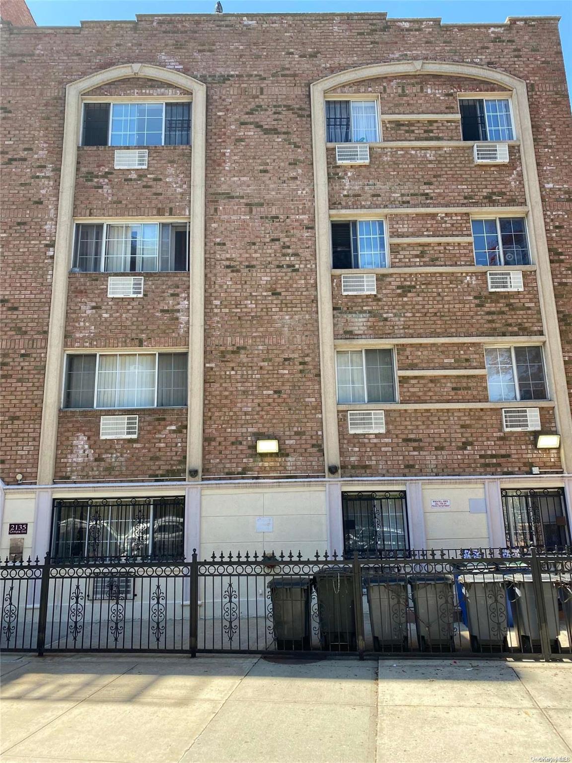 a view of a brick building with many windows