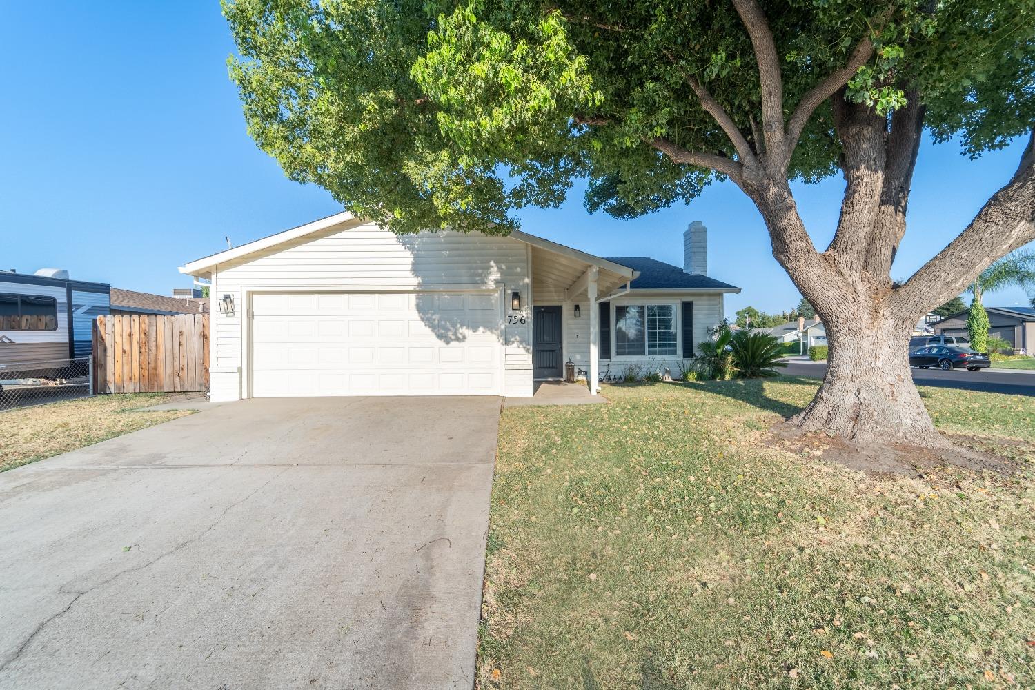 a view of a house with a tree in the background