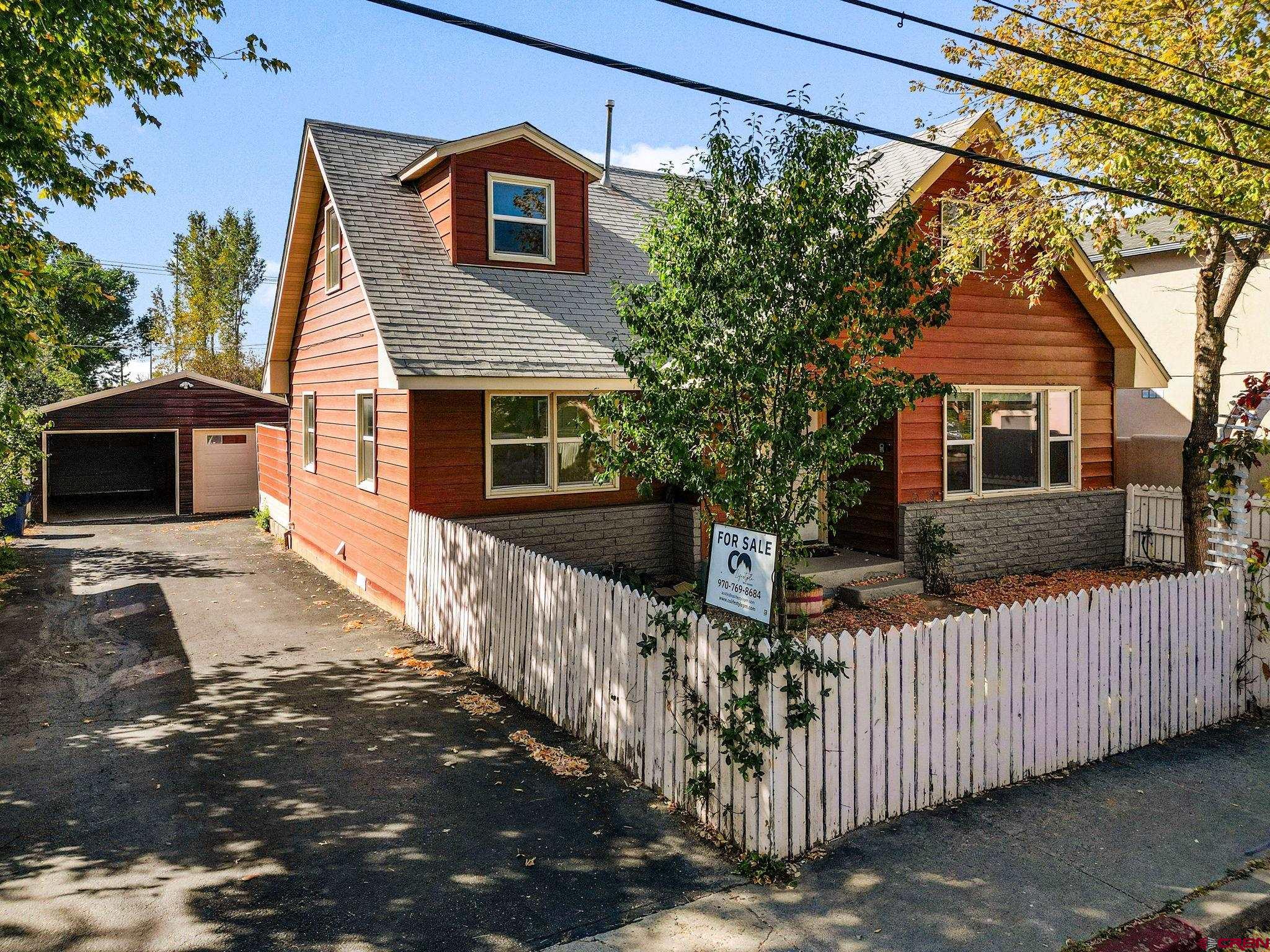 a front view of a house with wooden fence