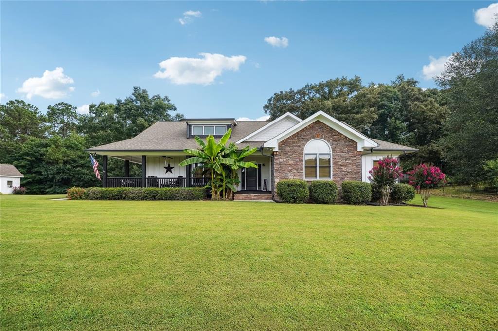 a front view of house with yard and green space